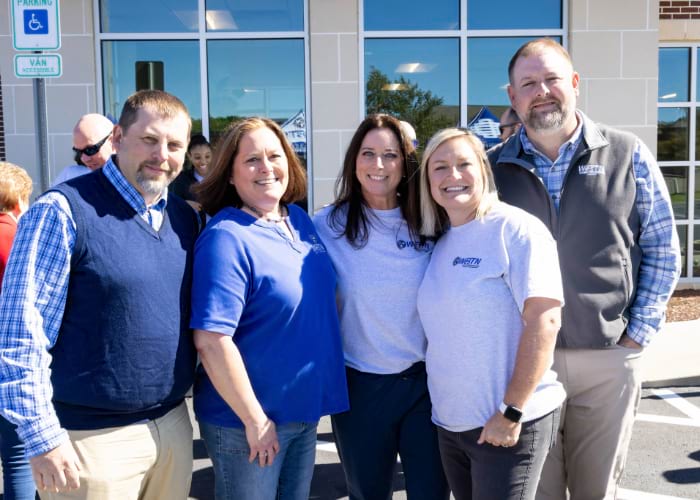 Workers of the West Tennessee Bank posing in front of the building for the 125th anniversary