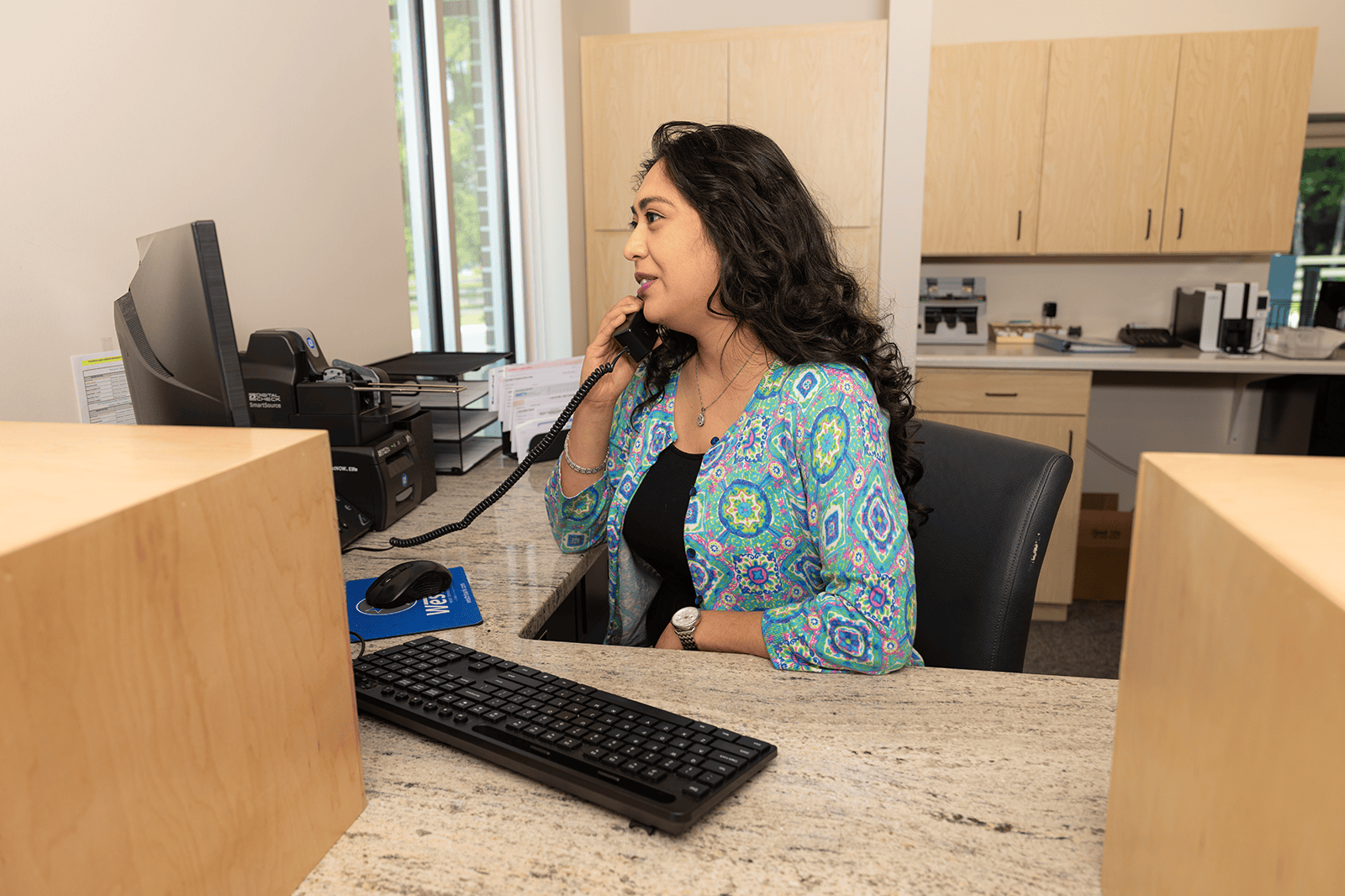 Nori answering the phone at the Brownsville branch