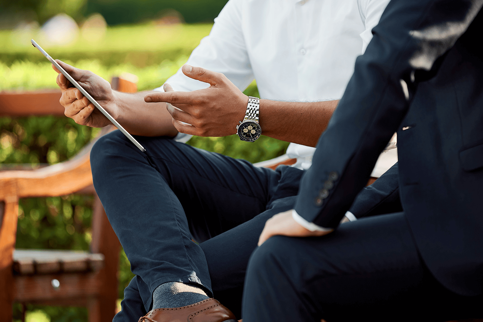 Two men discussing a business plan pulled up on a tablet