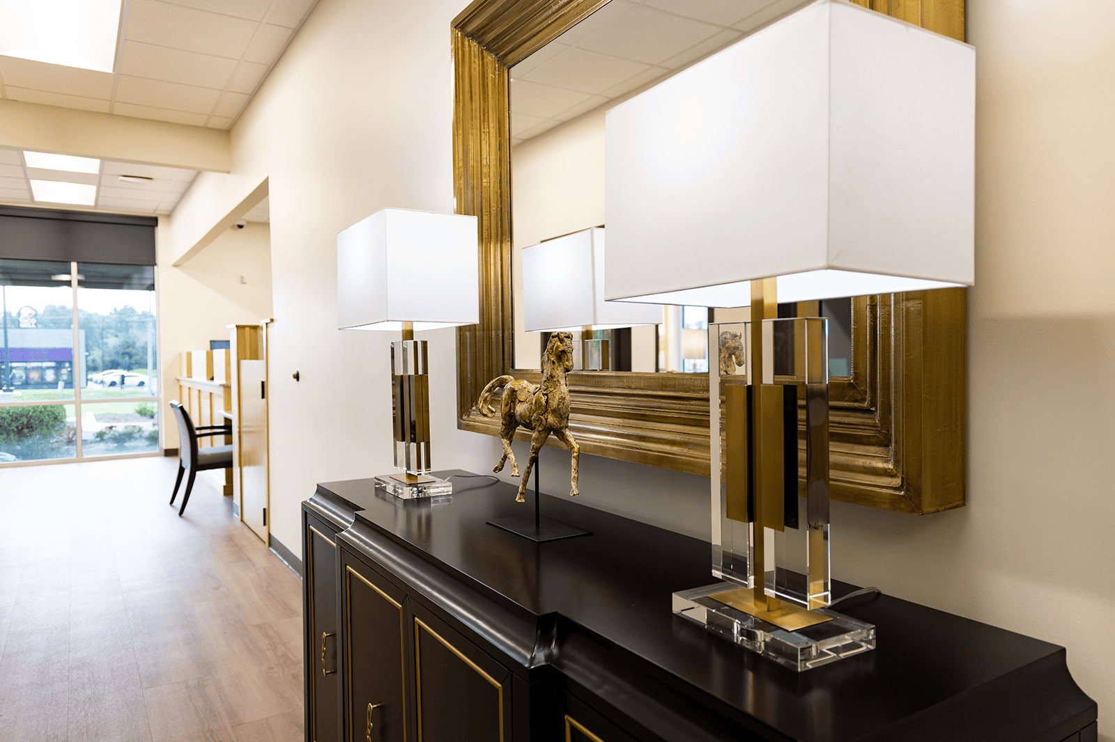 Three upscale lamps line a hallway in the Brownsville Branch