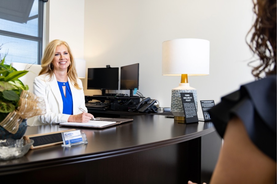 JoAnna Morris helping a Business account customer with cash management