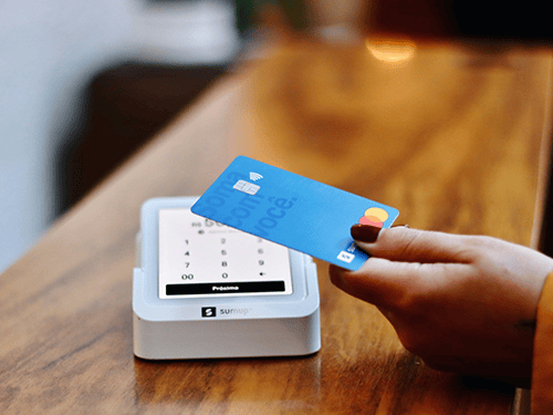 Mastercard next to a tap card reader