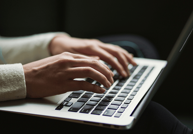 Lady typing on laptop
