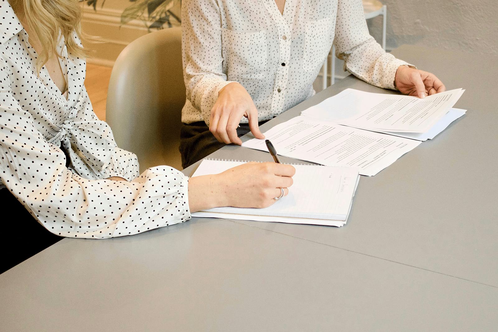 Two women working on the documents of Terms and Conditions