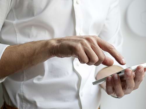 Man going to press his phone to continue